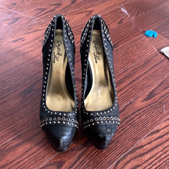 Very high black heels with gold detail. - Picture 3 of 4